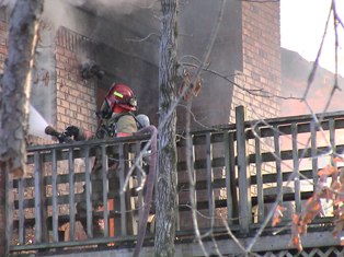 Firefighter putting out a fire on a building